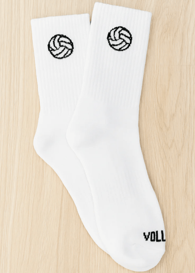 White socks with volleyball designs on a wooden surface